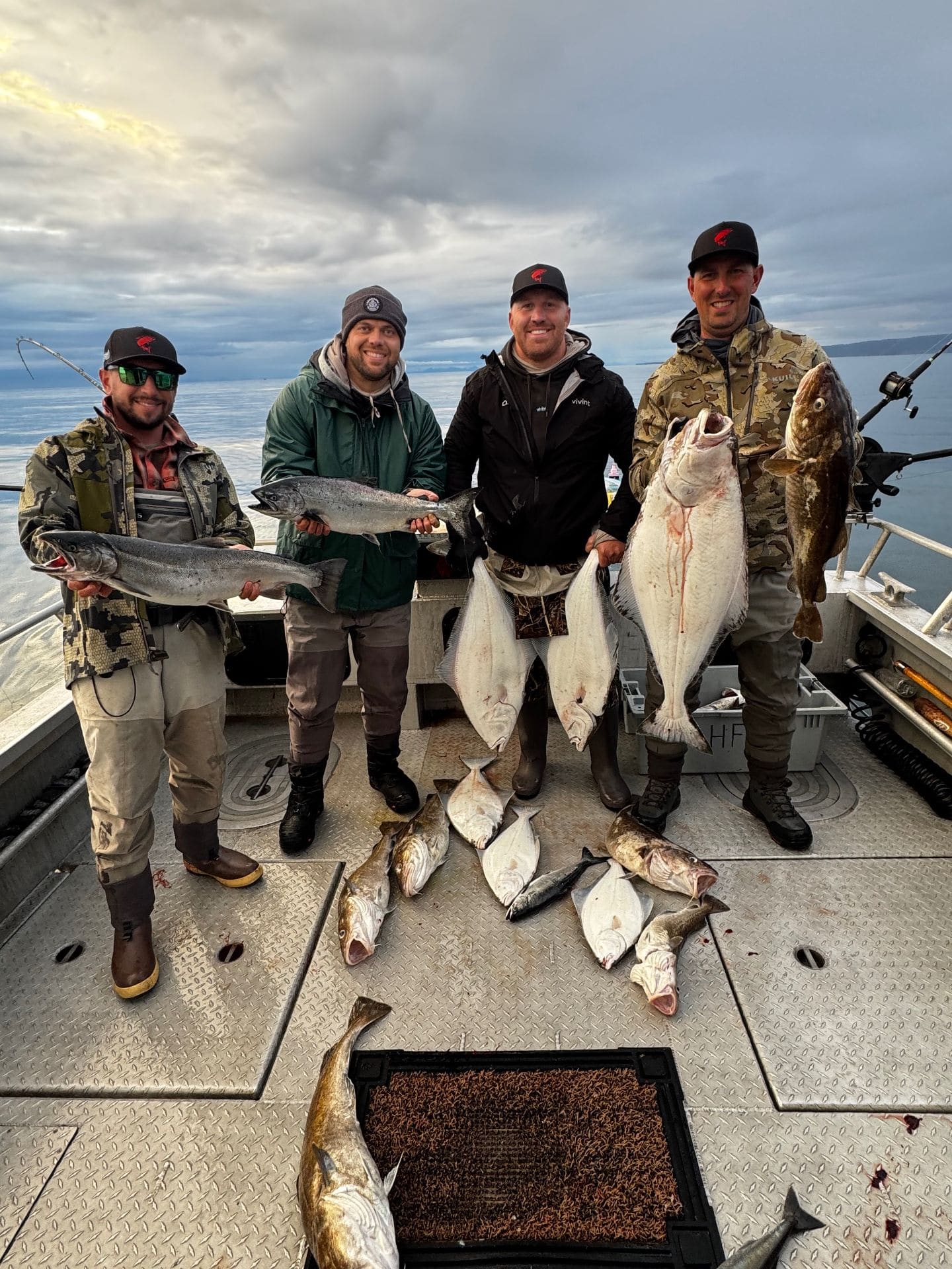 Group of friends with halibut, salmon, and cod catch