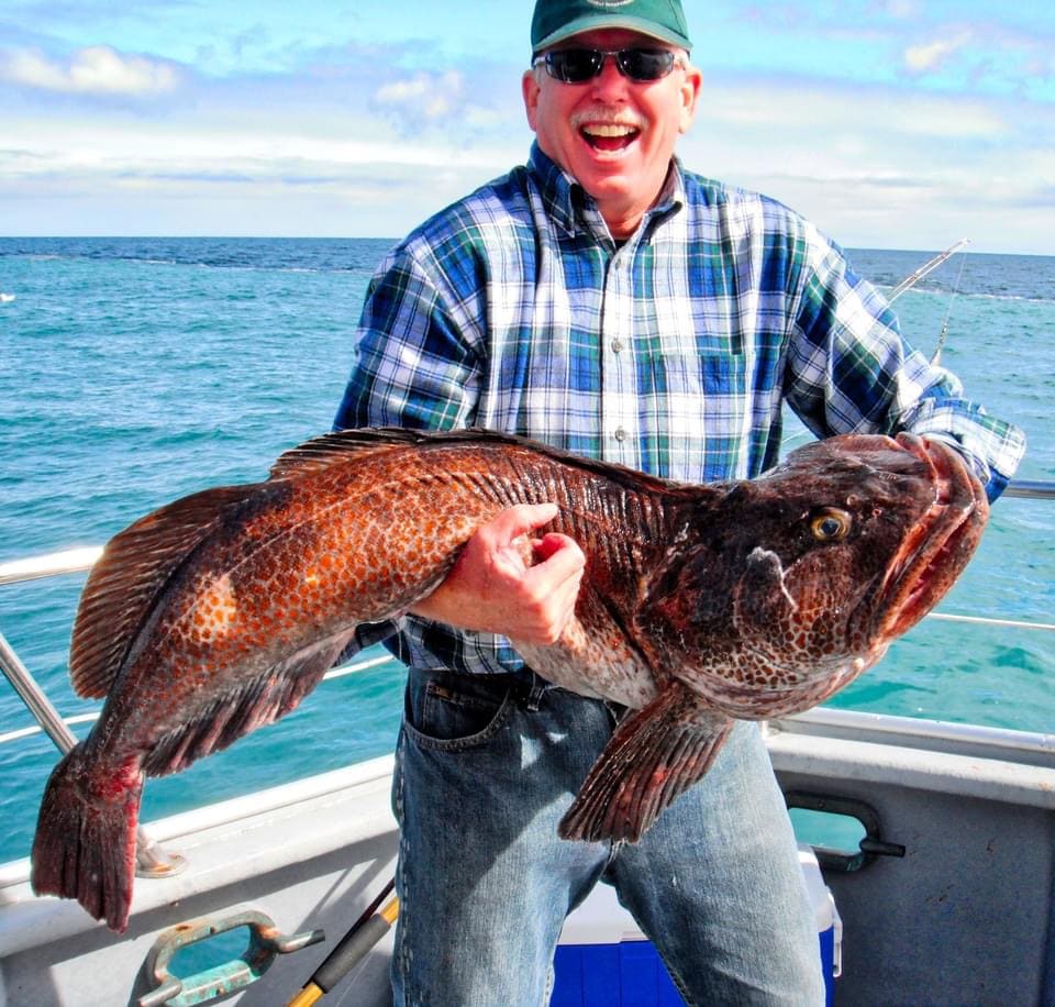 Happy angler with a large lingcod catch