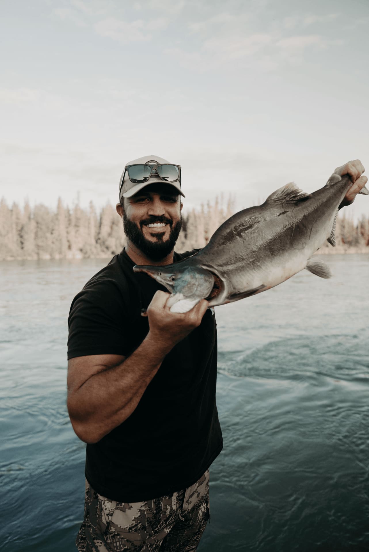 Angler holding a large salmon on the river