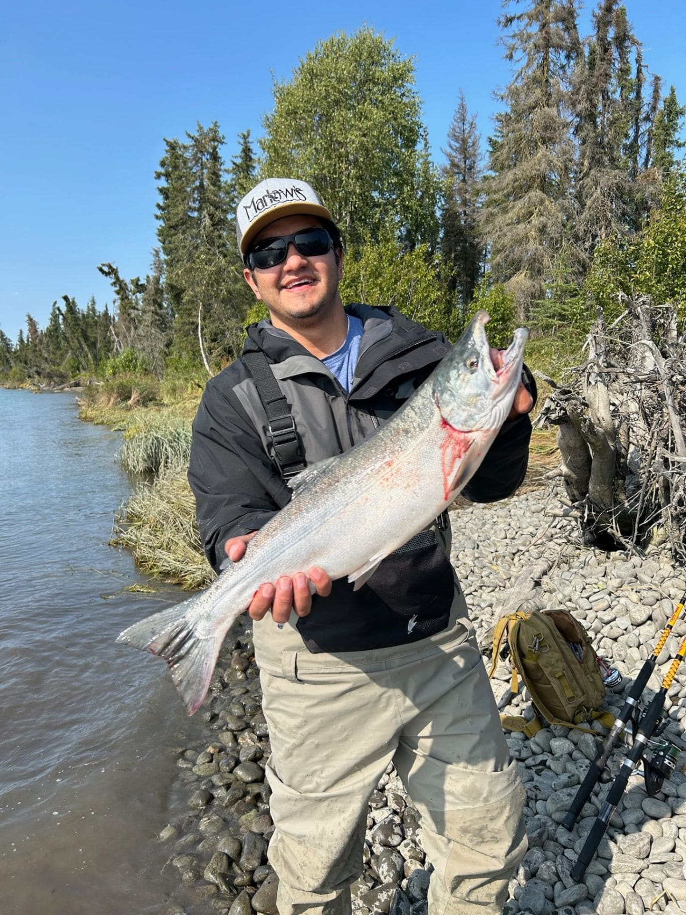 Angler holding a large salmon in waders