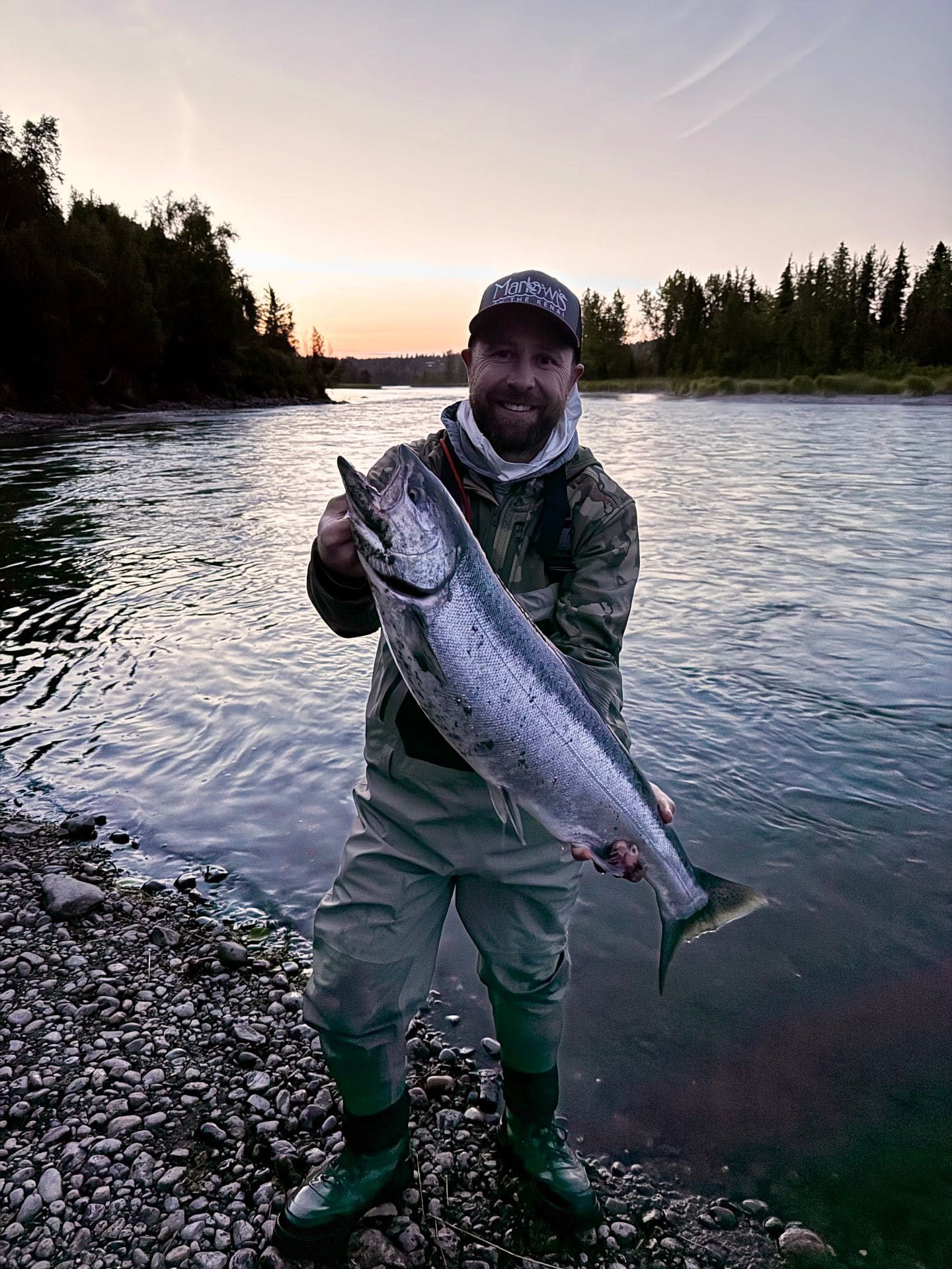 Angler with salmon at sunset on the Kenai