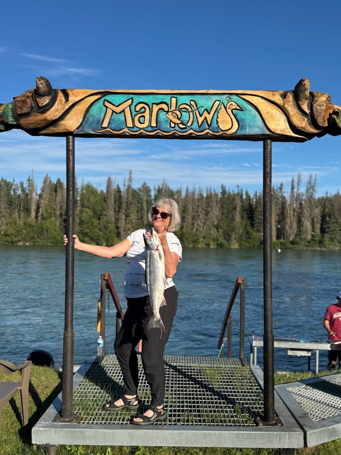 Happy angler showing off her catch on the dock