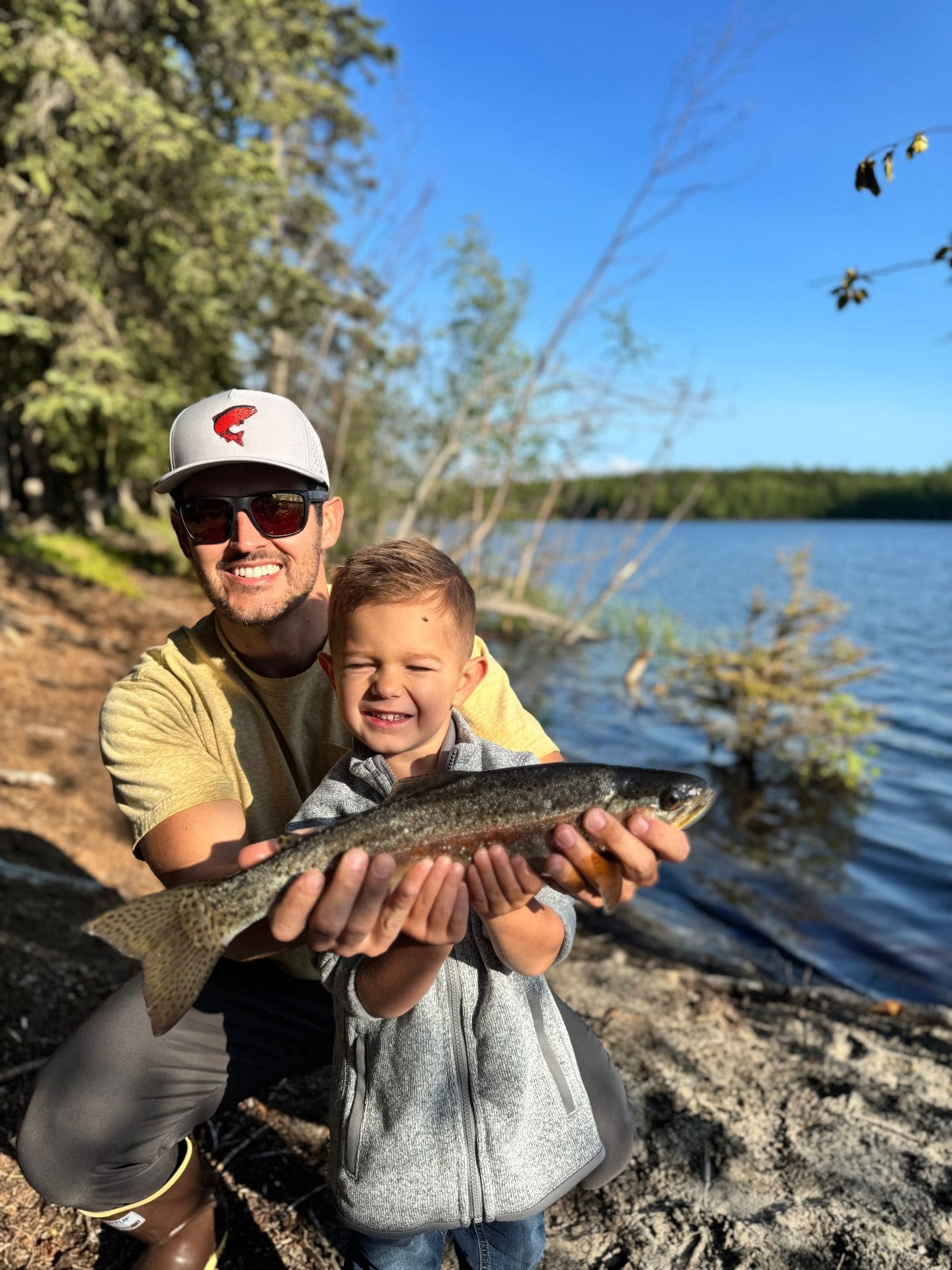 Father and son with a trout catch at a local lake